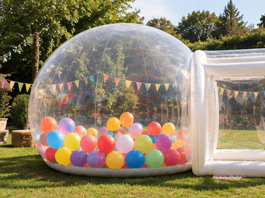 The Bubble filled with bright rainbow balloons and colourful bunting at a garden party