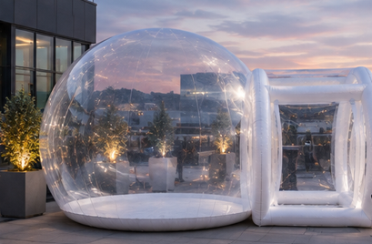 The Bubble on a rooftop terrace at sunset with city views and twinkling lights